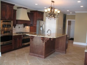 Custom Home Kitchen, Wall-Mounted Double Stack Ovens, Custom Range Hood, Center Island, Brass / Crystal Chandelier, Stainless Steel Appliances - Madison Custom Homes Inc., Indianapolis, Indiana