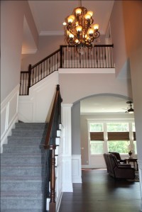 Luxury Home Foyer: Design Detail Close-up, Carpeted Hardwood Staircase, Wrought Iron and Oak Banisters, Crown Molding Accent; Luxury Homes Built to Your Specifications; Indianapolis, Indiana - Madison Custom Homes Inc.