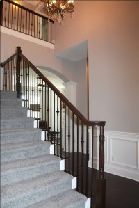 Luxury Home Foyer: Design Detail Close-up, Carpeted Hardwood Staircase, Wrought Iron and Oak Banisters, Crown Molding Accent; Luxury Homes Built to Your Specifications; Indianapolis, Indiana - Madison Custom Homes Inc.