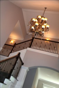 Luxury Home Foyer: Design Detail Close-up, Carpeted Hardwood Staircase, Wrought Iron and Oak Banisters, Crown Molding Accent; Luxury Homes Built to Your Specifications; Indianapolis, Indiana - Madison Custom Homes Inc.