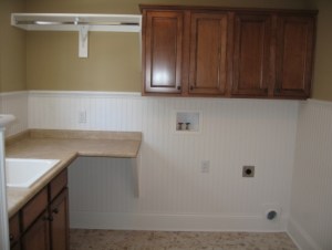 Custom-Built Luxury Home Laundry Room: Utility Sink Counter, Folding Table, Hanging Rack, Wall Mounted Storage Cabinets, Luxury Homes, Indianapolis, Indiana