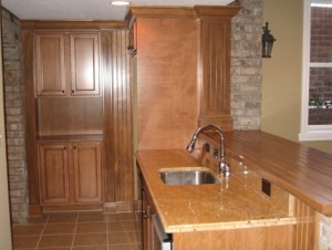Luxury Home Noblesville: Basement, Custom-Built Wet Bar, Granite-Topped Sink Counter, Brick Face, Oak Bar Top / Cabinets - Madison Custom Homes Inc., Indianapolis