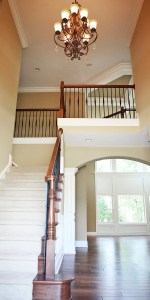 Carpeted Hardwood Staircase, Oak / Wrought Iron Banisters, Crown Molding Accents