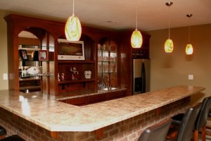 Luxury Home Noblesville: Basement, Custom-Built Wet Bar, Brick Face, Marble Top, Mirrored Shelves, Refrigerator, Drop Lighting - Madison Custom Homes Inc., Indianapolis, Indiana
